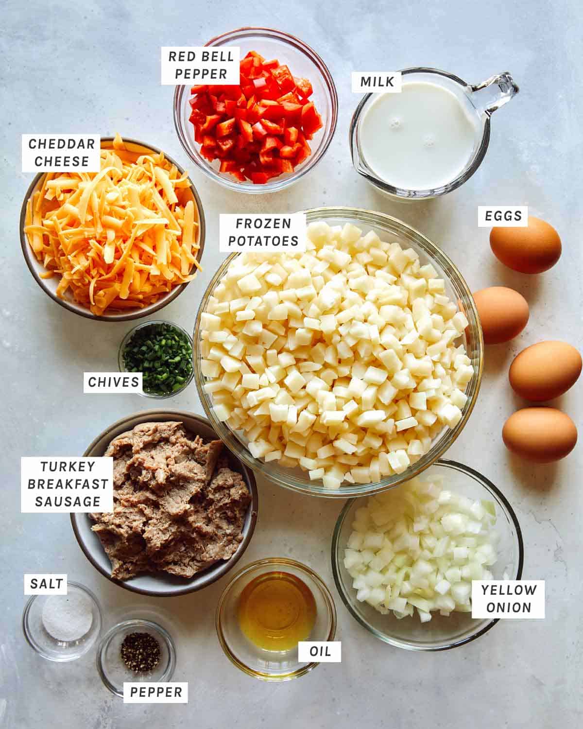 Ingredients in a breakfast casserole recipe all laid out on a kitchen counter. 