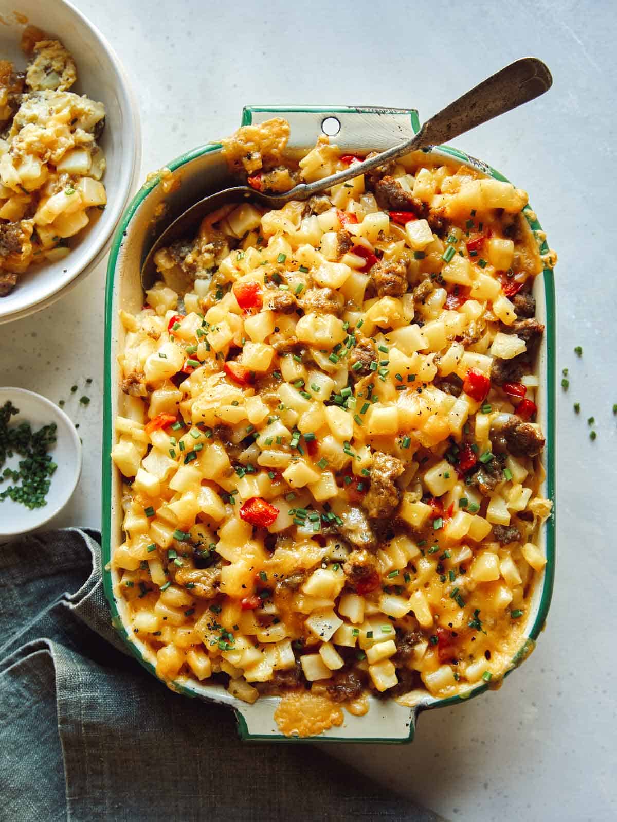 Breakfast casserole with a spoon in it. 