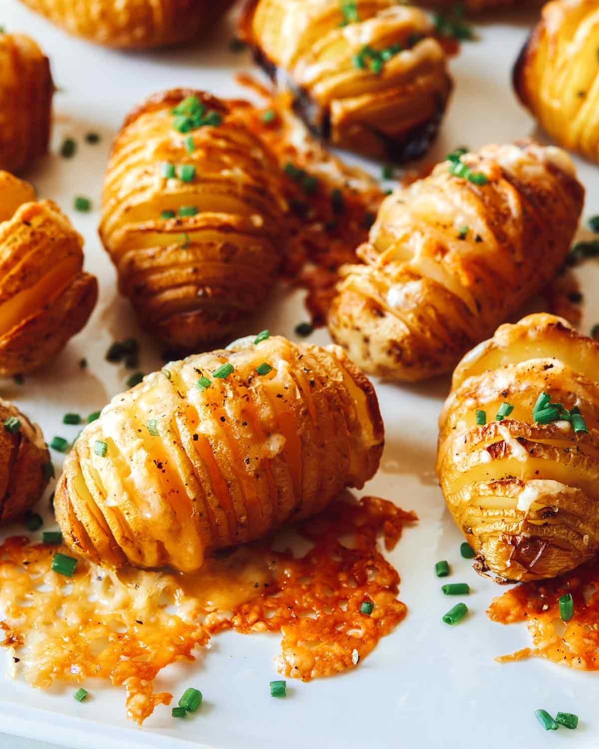 Close up on hasselback potatoes on a platter.