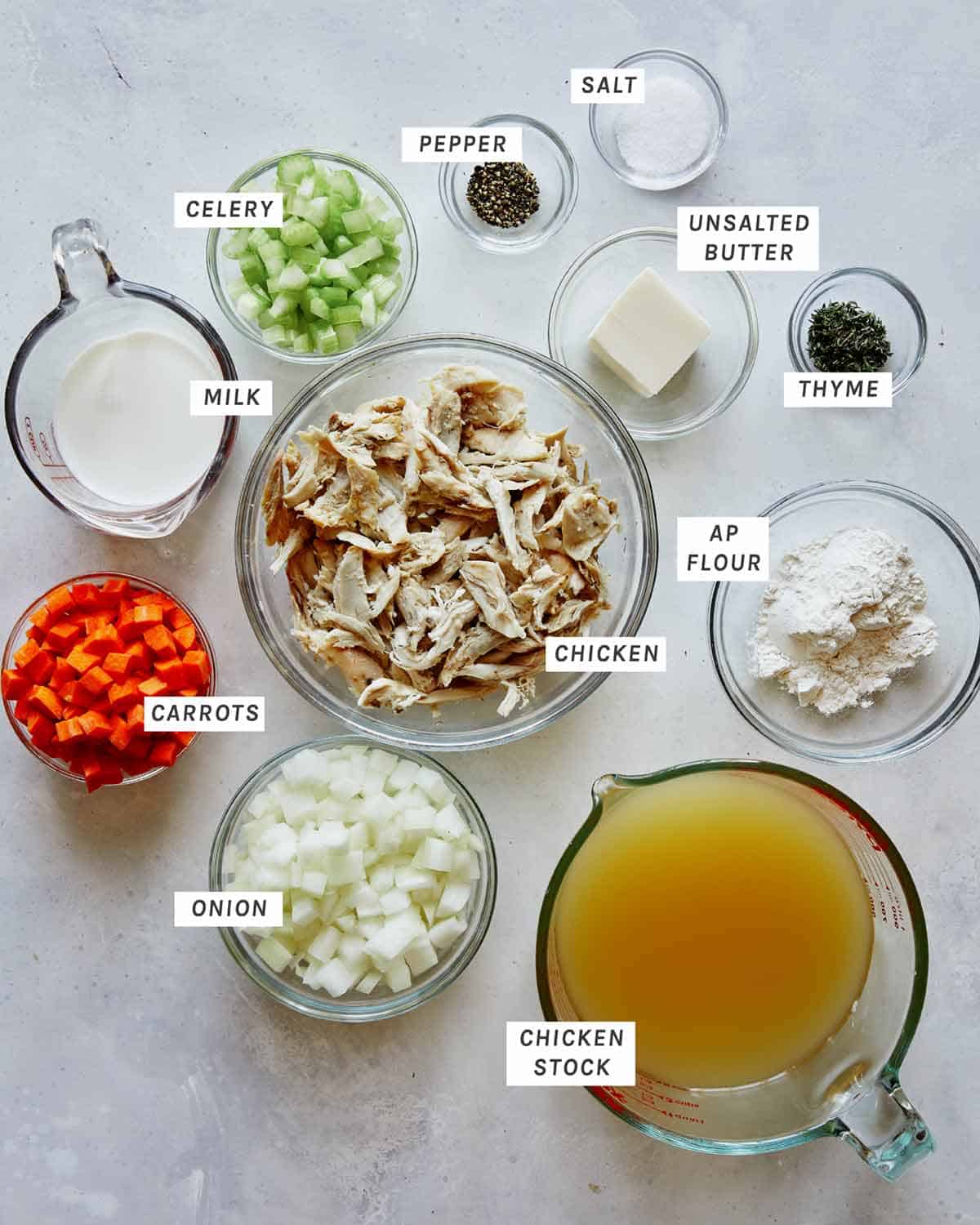 Ingredients for chicken soup to make easy chicken and dumplings all laid out on a kitchen counter. 