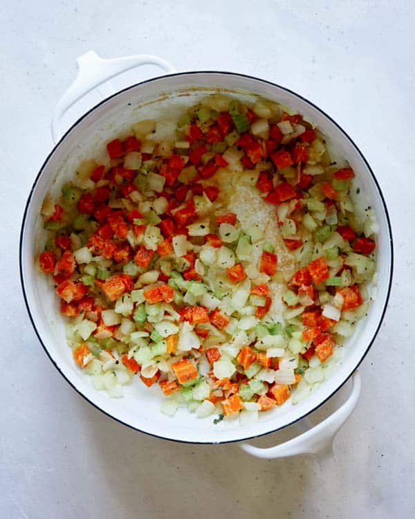 Vegetables in a pot with flour and herbs.