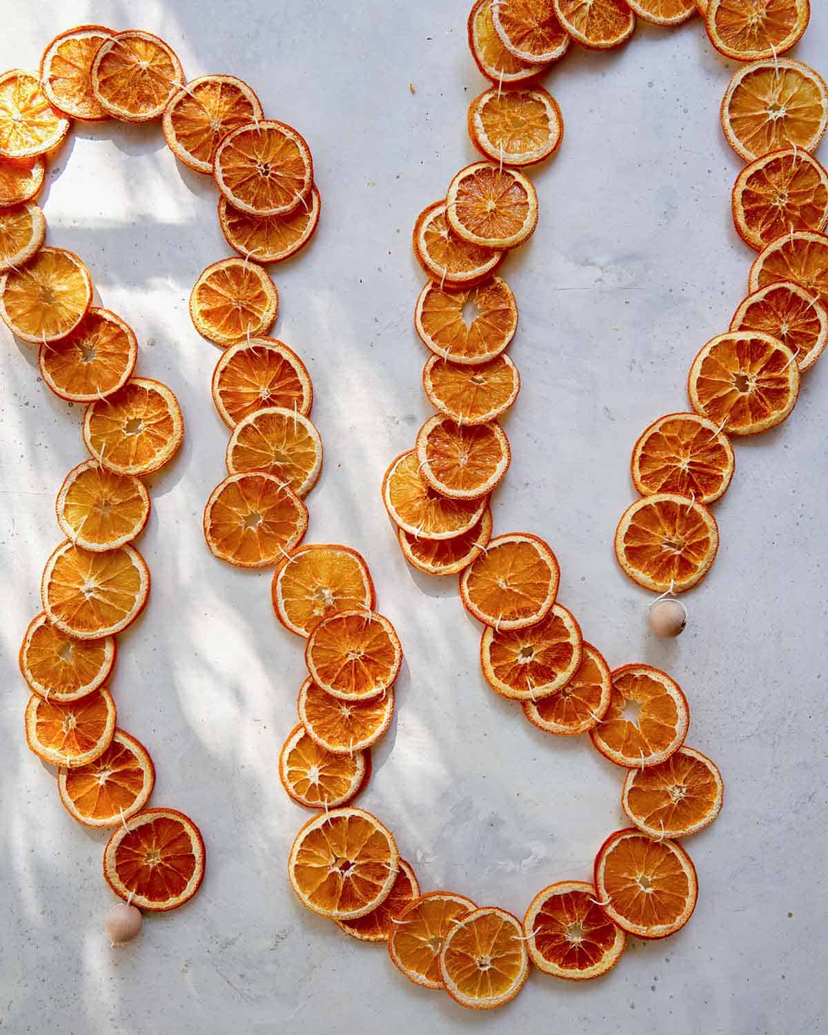 A dehydrated citrus garland laid out on a table.