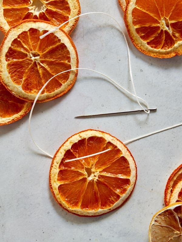 Dehydrated citrus wheels strung on twine. 