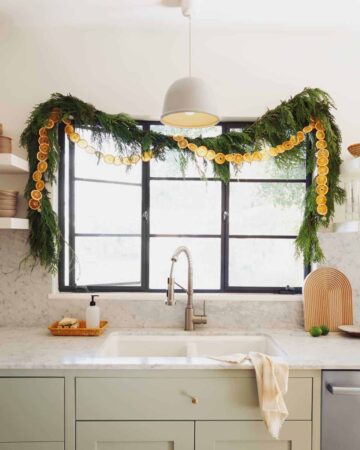 Dehydrated citrus garland strung up in a kitchen window.
