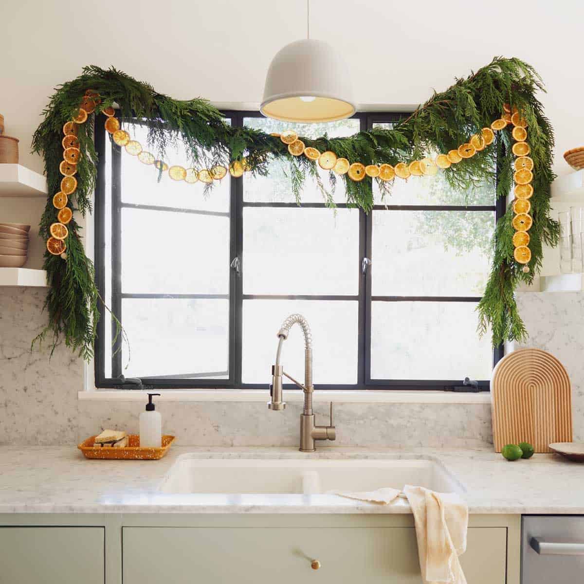 Dehydrated citrus garland strung up in a kitchen window.