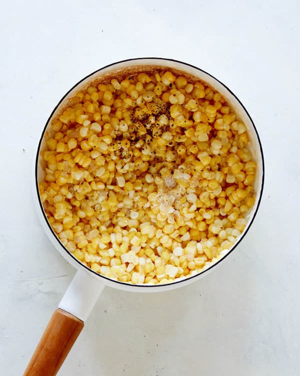Corn in a pot overhead in a kitchen.