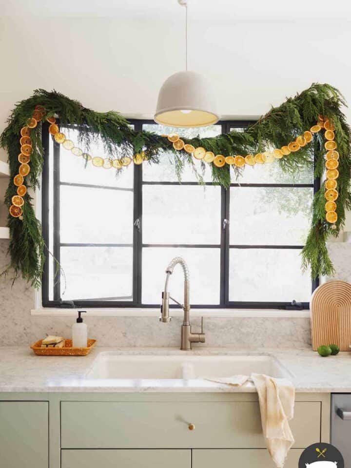 Dehydrated citrus garland strung up in a kitchen window.