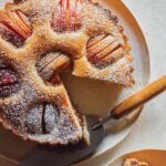 German Apple Cake on a platter with a slice out.