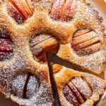 German Apple Cake on a platter with a slice out.