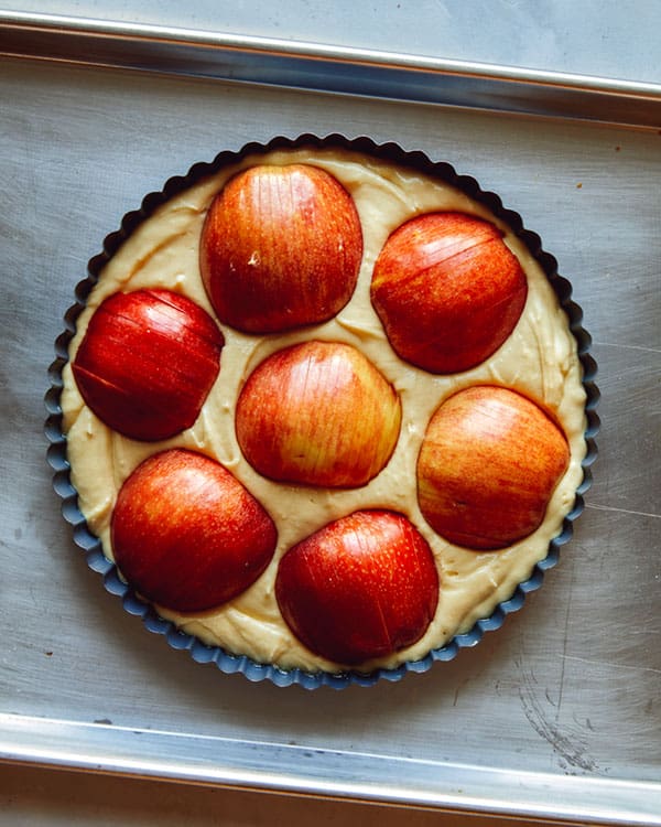 German apple cake ready to be baked in an oven.