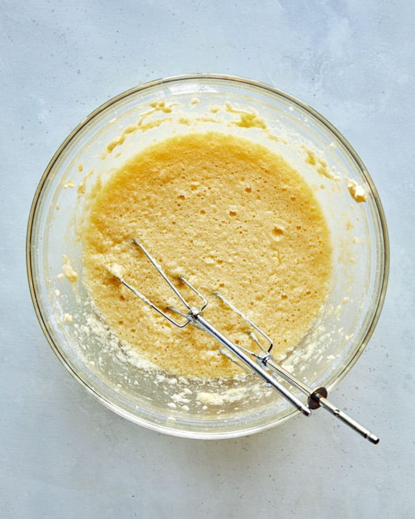 Batter for german apple cake in a glass bowl.