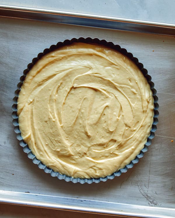 Batter in a tart pan ready to be baked.