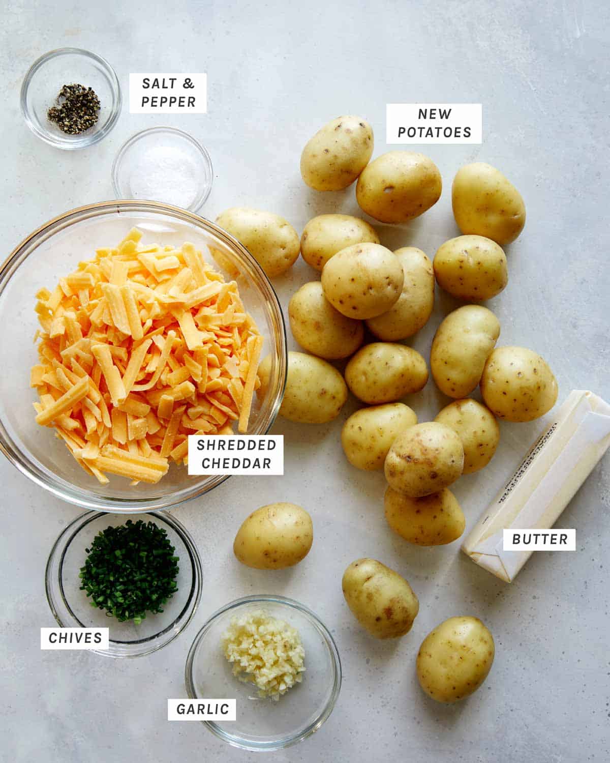 Ingredients to make hasselback potatoes all laid out on a kitchen counter.