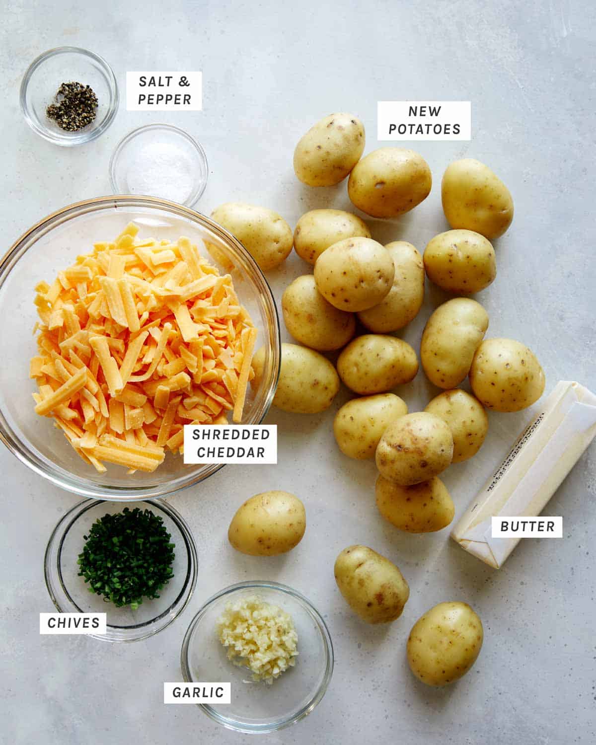 Ingredients to make hasselback potatoes all laid out on a kitchen counter. 