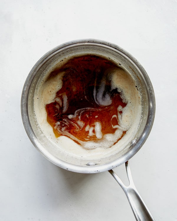 Browned butter in a skillet on a white background.