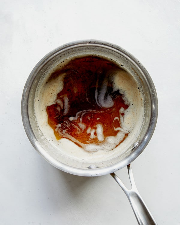 Browned butter in a skillet on a white background.  