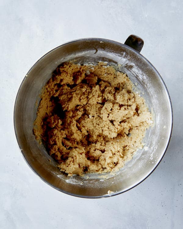 The dough for kitchen sink cookies in a stand mixer bowl. 