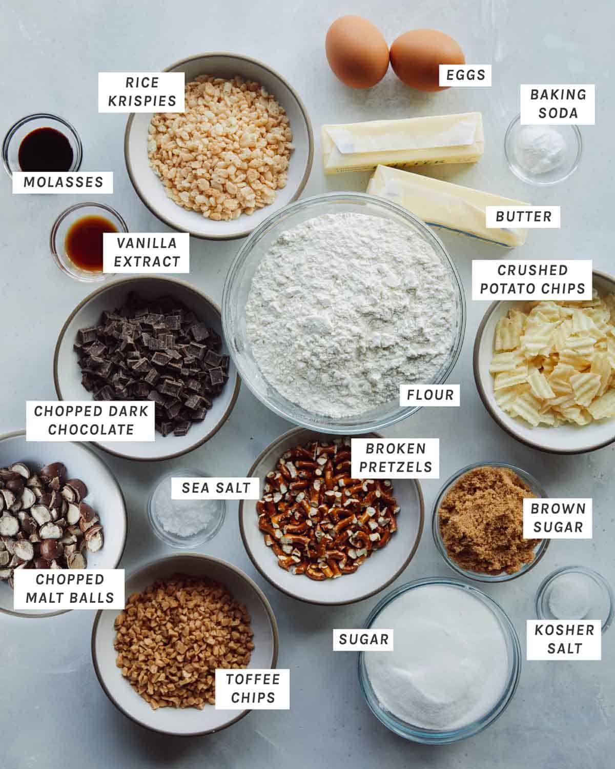 Ingredients to make kitchen sink cookies all laid out on a kitchen counter. 