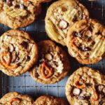 A close up of kitchen sink cookies on a cooling rack.