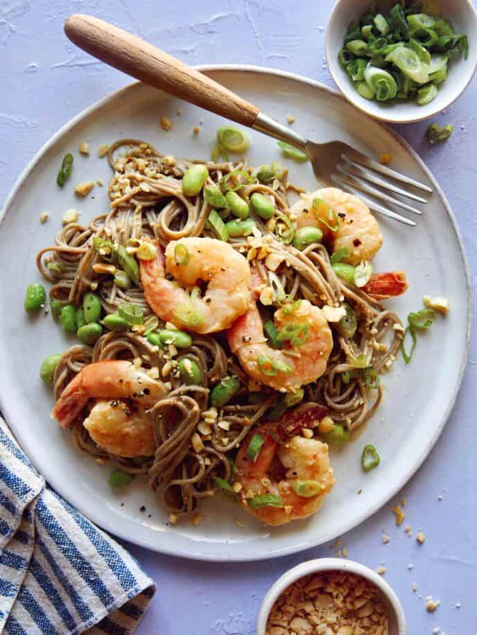 One plate of shrimp soba noodles with a fork.