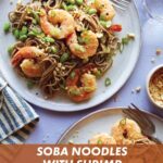 Soba noodles with shrimp on two plates with forks and garnish next to it.