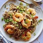 Close up on a soba noodle recipe with shrimp and a fork with it.