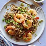 Close up on a soba noodle recipe with shrimp and a fork with it.