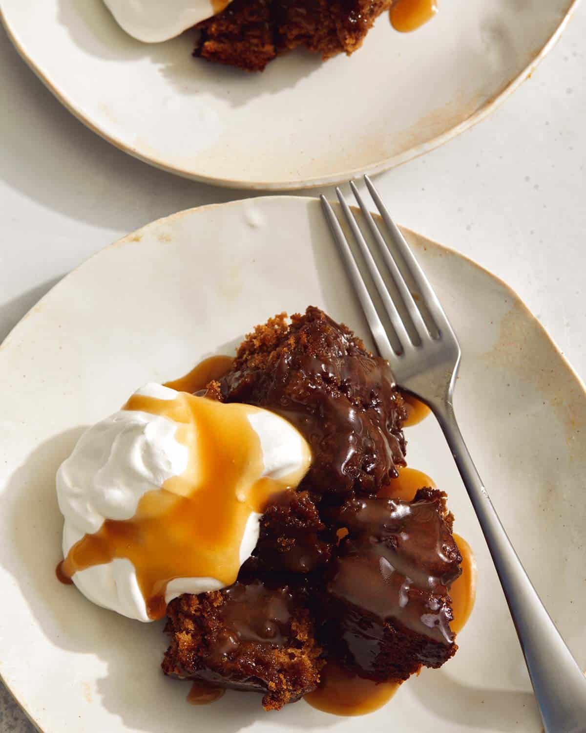 Sticky toffee pudding recipe plated with a fork. 