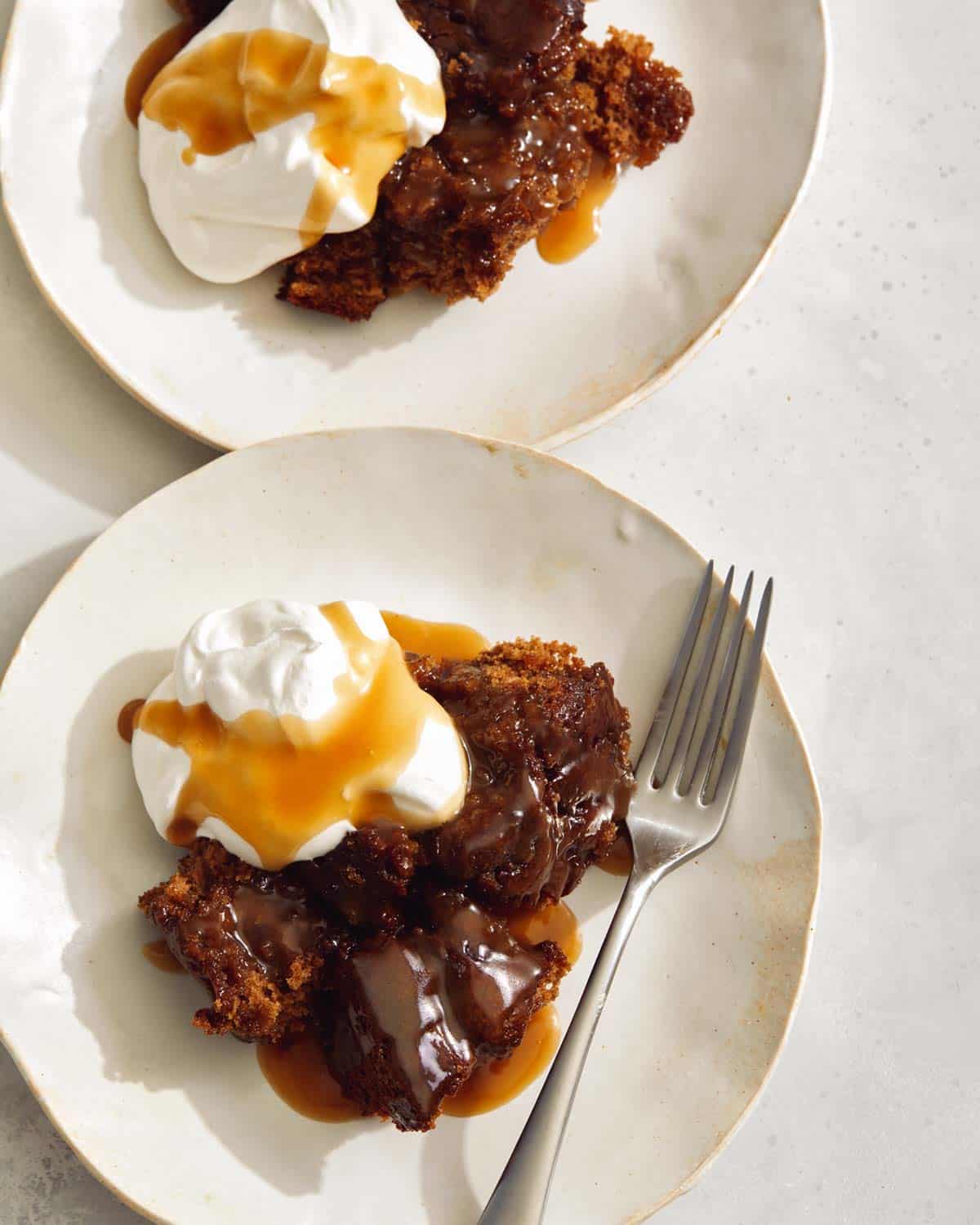 Sticky Toffee pudding recipe in two plates with a fork. 