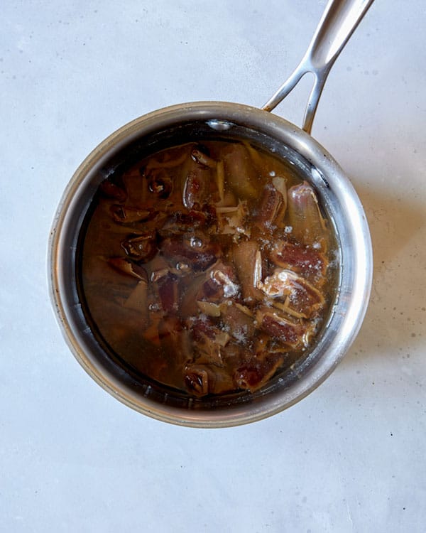 Dates in a pot boiling to make sticky toffee pudding.