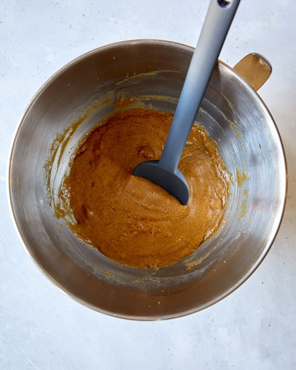 Eggs, cream, and sugar in a bowl for sticky toffee pudding.