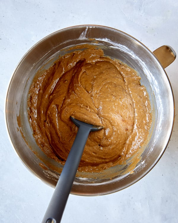 Eggs, cream, and sugar in a bowl for sticky toffee pudding.