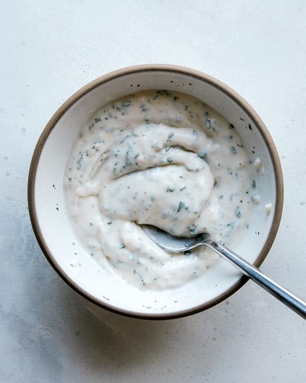 Aioli mixed together in a bowl with a spoon.