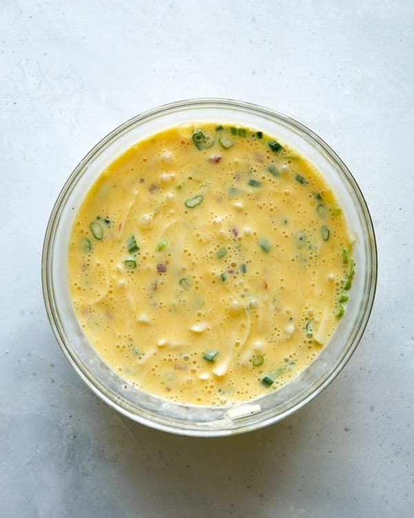 Baked egg boats ingredients in a mixing bowl.