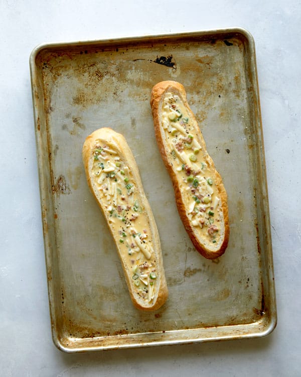 Baked egg boats pre baked on a baking sheet.