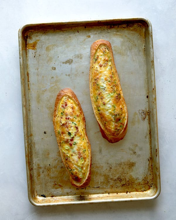 Baked egg boats on a baking sheet.