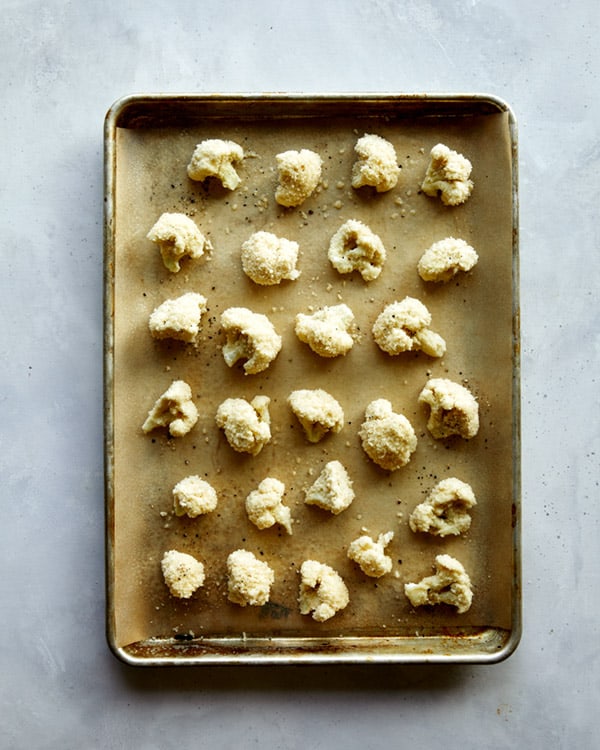 Cauliflower florets baked on a baking sheet.