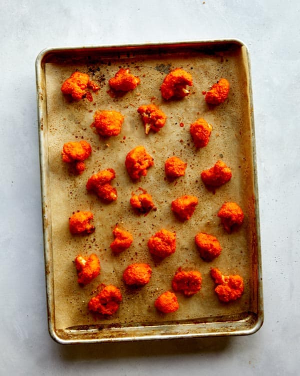 Buffalo cauliflower on a baking sheet.