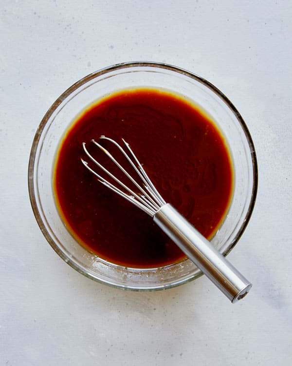 Cooking sauce in a glass bowl for chicken lettuce wraps.