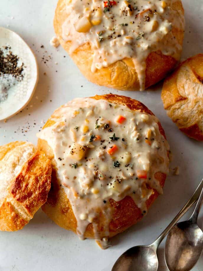 Clam chowder in two bread bowls.