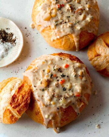 Clam chowder in two bread bowls.