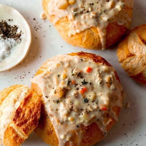 Clam chowder in two bread bowls.