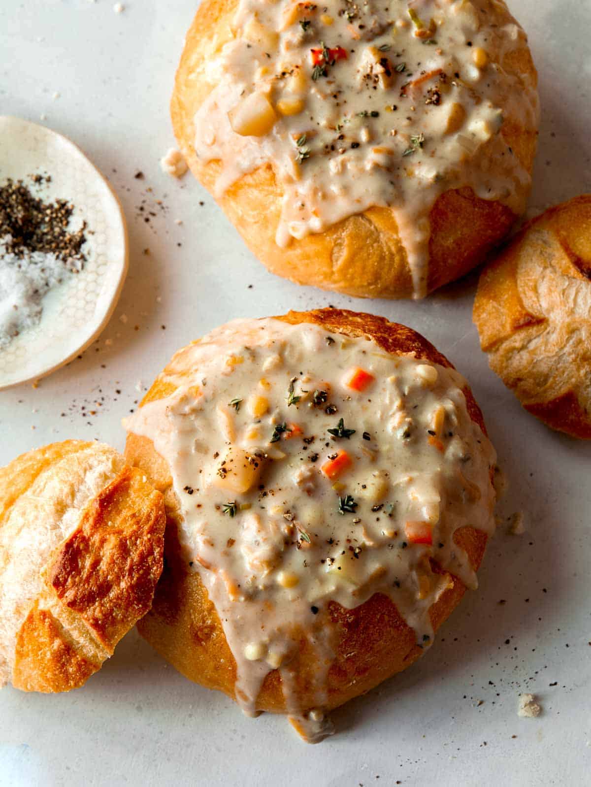 Clam chowder in two bread bowls.