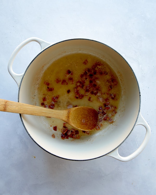 Butter and bacon in a pot to make the start of clam chowder.