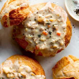 Close up on a bread bowl with clam chowder.