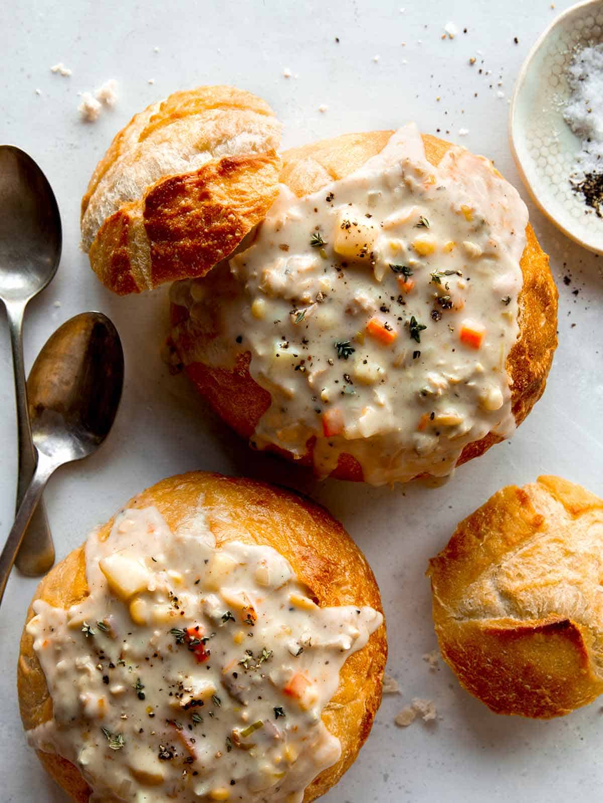 Clam chowder in two bread bowls.