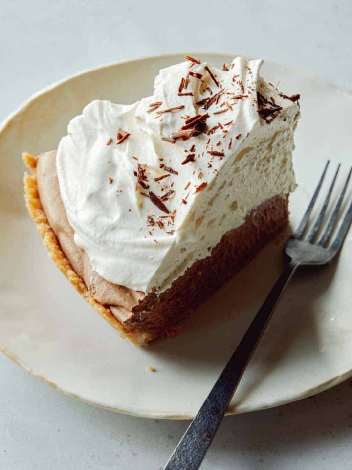 A slice of french silk pie on a plate with a fork next to it.