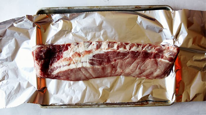 Ribs on a baking sheet with foil.