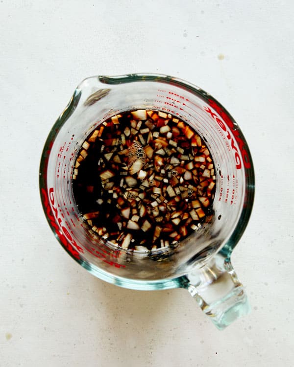 Oven baked ribs marinade ingredients in a measuring cup.