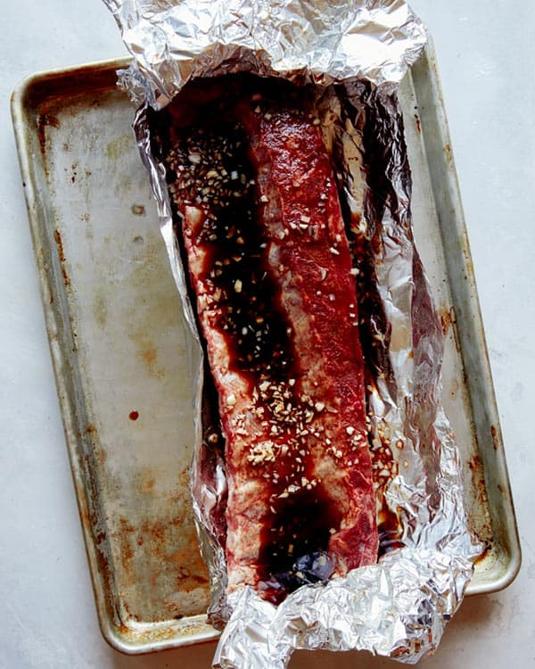 Oven baked ribs with marinade in tin foil